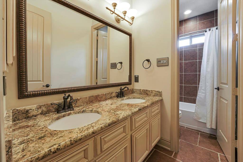 Experience convenience in Guest Bath 2 with its dual sinks and a tub-shower combo.