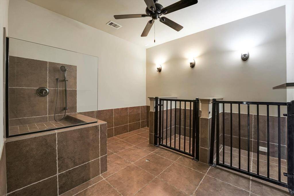 This home features a spacious, tiled pet room with three kennels and a wash station, complete with cleanout drains. Ensure your pets are safe and secure while you're away.