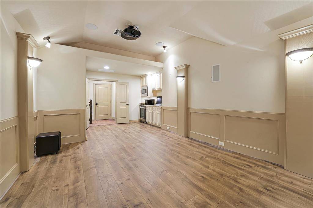 Elevate your entertainment with this spacious upstairs theater room, featuring a kitchenette, guest bath, and optional projector for unforgettable movie and sports nights.