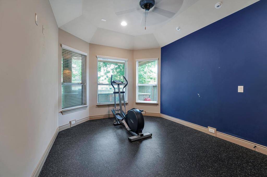 Elevate your fitness routine in this dedicated exercise room with performance-enhancing custom flooring.