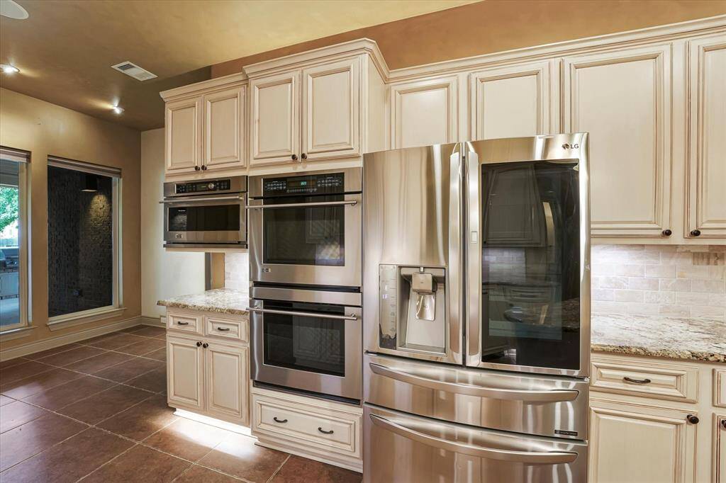 Experience a chef's delight with ambient under-cabinet and floor lighting, complemented by a professional-grade gas cooktop and plenty of counter/cabinet space
