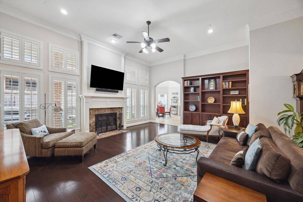 A gas log fireplace with a natural stone surround is the anchor of the room.   Conveniently there is a mantle-mounted pull-down TV mount above the fireplace (TV excluded from a sale).