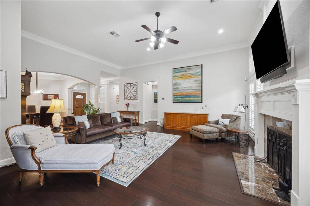 One last perspective of this wonderful, open living space with great light.  The hall just to the left of the credenza leads to the primary suite.