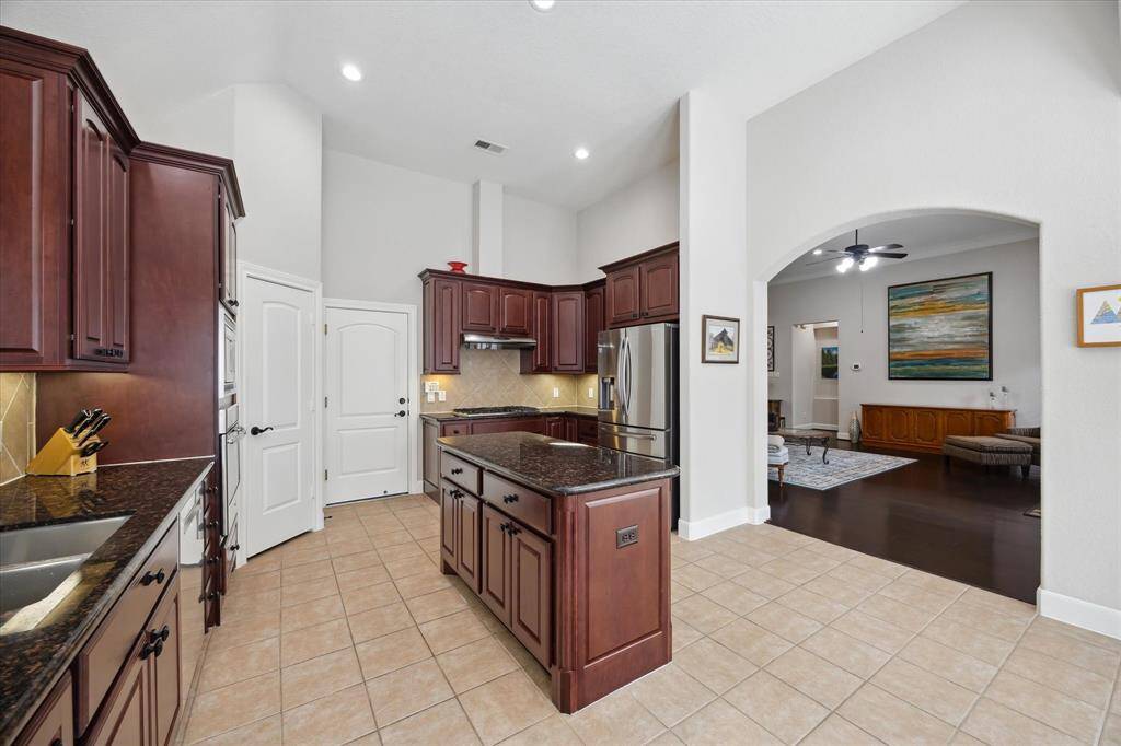 Connected to the living area by a wide, arched doorway is this extraordinary kitchen.  The white door to the left leads to a walk-in pantry and the door to its right is to the garage.