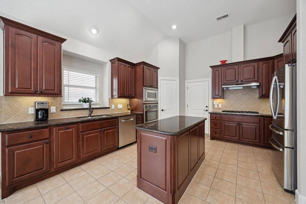 There is fabulous counter space as well as a wide, double bowl sink complete with a window.  All appliances are stainless including the five burner cooktop.