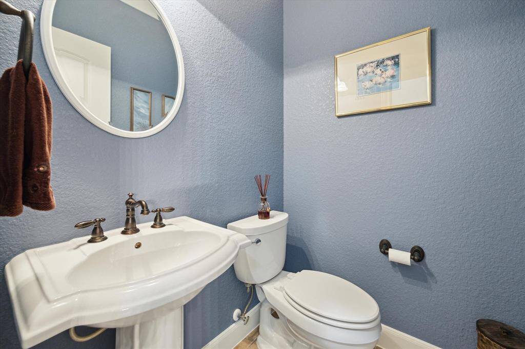 In the guest room section of the home you'll find a convenient and beautifully finished half bath.