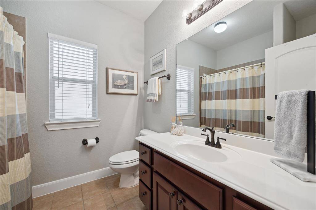 Sitting between the two guest bedrooms is a full bath with tub/shower combo, single sink and excellent counter and cabinet/drawer space.