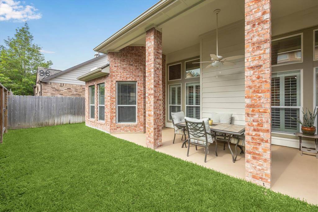 The back yard is a perfect, private oasis complete with a covered patio with ceiling fan.
