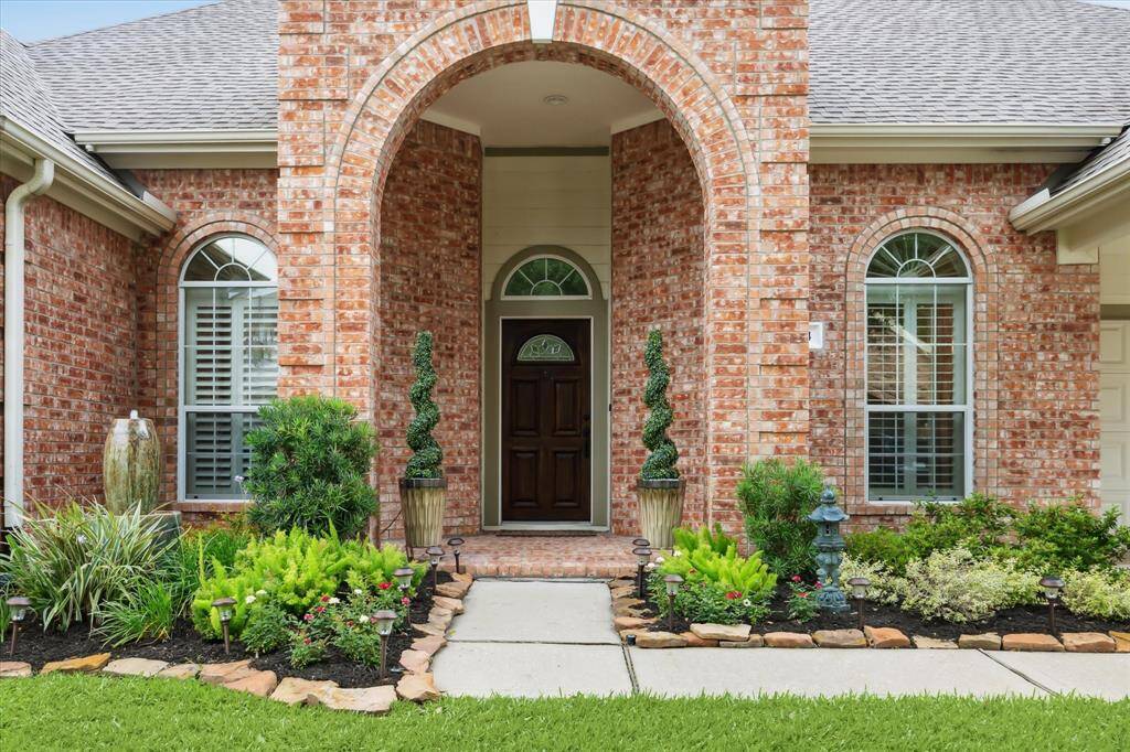 The yard has been thoughtfully lanscaped with a paver path leading to the covered entry.