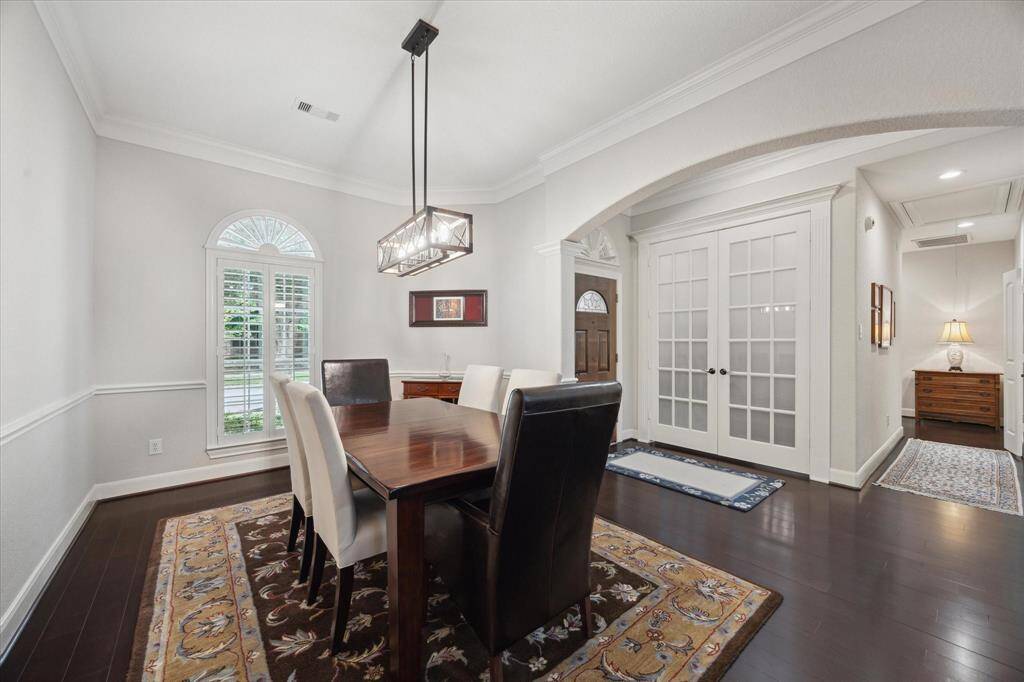 Elegant finishes include beautiful hardwood floors and plantation shutters.  The French doors lead to a perfect home office.