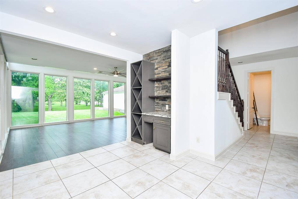View from entry looking to the sunken living area and stairs leading to second floor