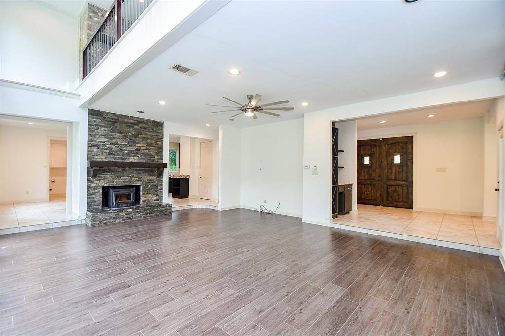 Living area with views of the entry hall, wood burning fireplace and breakfast area