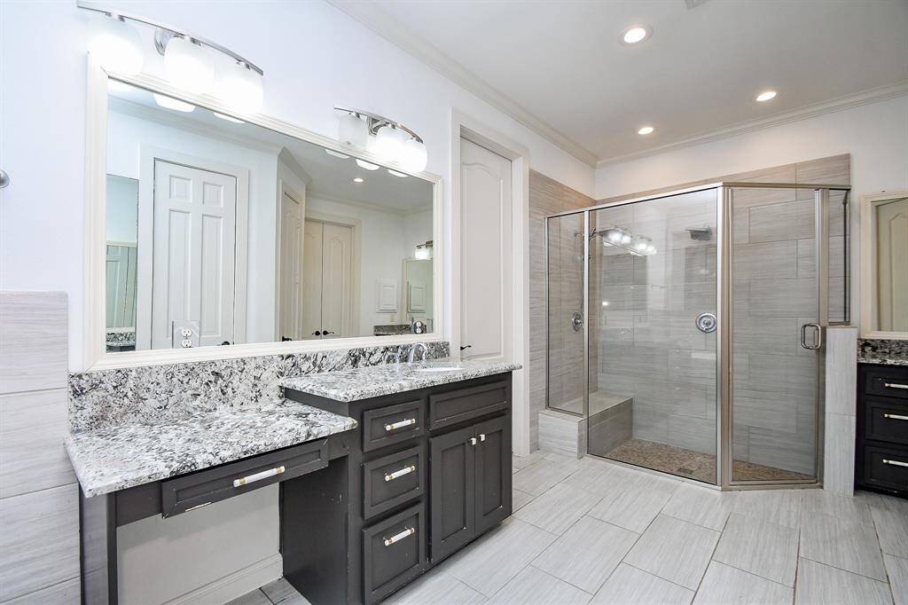 Primary bath offers dual vanities and separate shower
