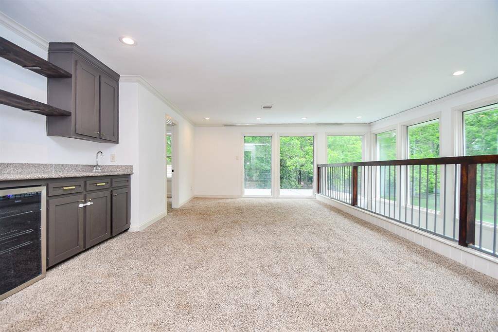 Loft boasts built in wet bar, fireplace, built in cabinets and floating shelves