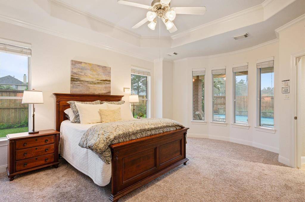 The luxurious first-floor primary suite is a true sanctuary, thoughtfully designed to provide comfort, privacy, and elegance. The expansive layout easily accommodates large furnishings, and the generously sized bay window creates a serene sitting area.