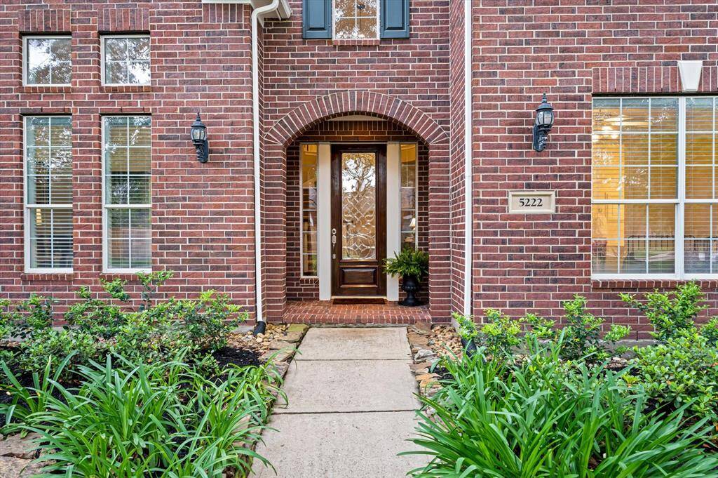 From the moment you arrive, you’ll be captivated by its impeccable curb appeal—classic brick elevation, a charming covered entry, lush green lawn, mature trees, and expansive flower beds.