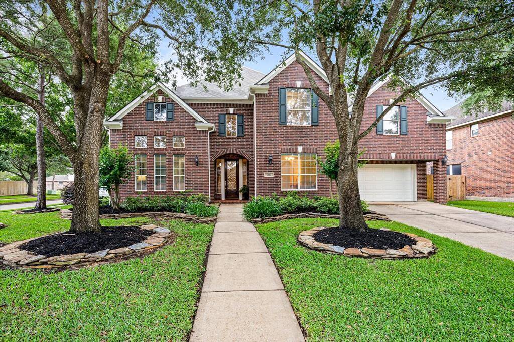 A convenient porte-cochère leads to a spacious 3-car tandem garage, offering both functionality and style.
