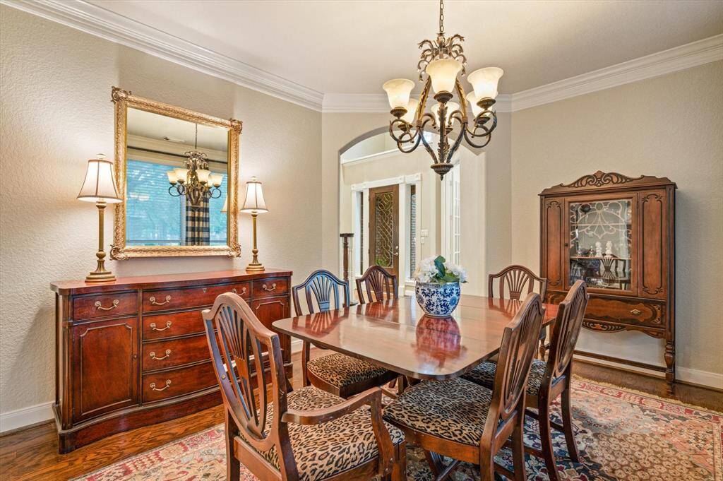 The formal dining room offers generous space to accommodate a large dining table, buffet, and china cabinet. Rich wood flooring sets a warm and inviting tone, while thick crown molding adds a touch of refinement to the room. Entertain with ease thanks to seamless access from the foyer, butler’s pantry, and kitchen.
