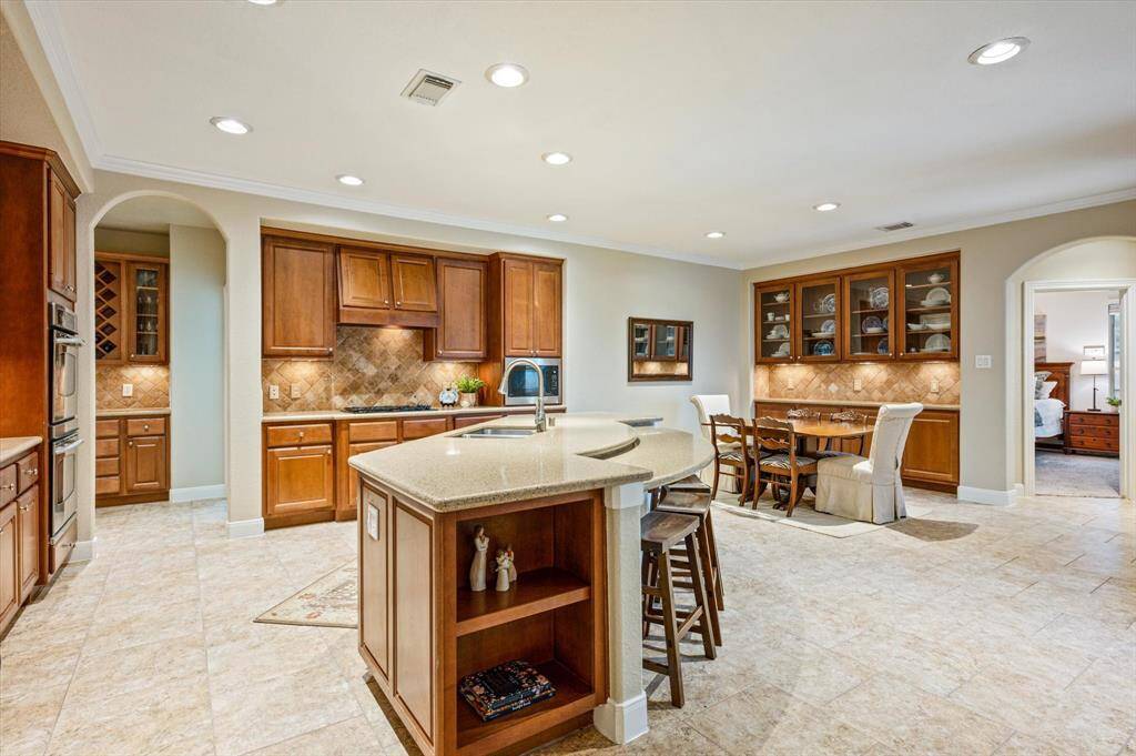 The chef-inspired kitchen is a true showstopper, thoughtfully designed to cater to both everyday living and elevated entertaining. From its spacious layout to its high-end finishes, every detail has been carefully considered.