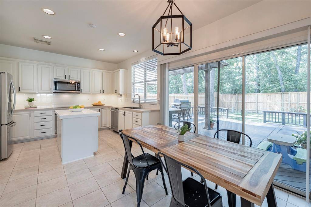 Light and bright kitchen near flex room. Lots of room for a kitchen table. Massive outdoor deck just beyond the marvelous glass doors.