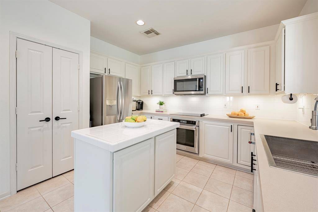 Every morning is cheerful in this lovely kitchen! Stainless farm sink, the best!