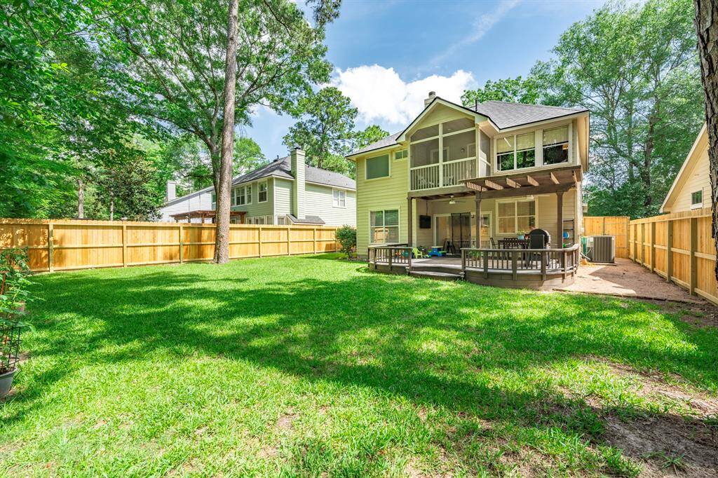 Back deck is another focal point of the home. So many great times right here! Replaced A/C unit (2018) can be seen in this photo.