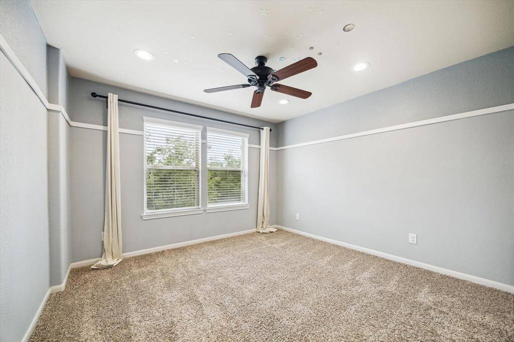 Another spacious guest room awaits, complete with plush carpet, designer paint, recessed lighting, and a ceiling fan for year-round comfort. With a total of five bedrooms and four full bathrooms, you will always have room for company.