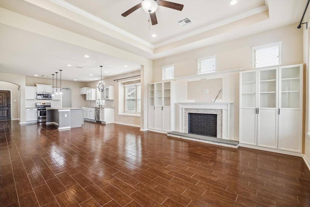 The open-concept layout seamlessly connects the kitchen and family room with a spacious dining area in between—perfect for casual meals or entertaining guests.