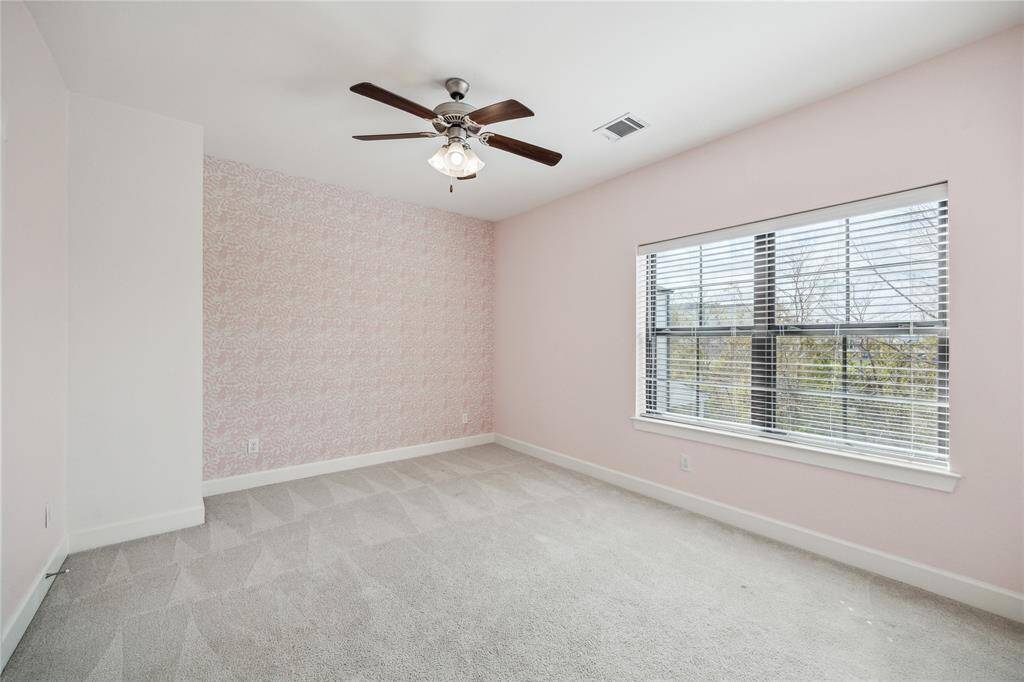 Another guest bedroom with tons of natural light and treetop views.