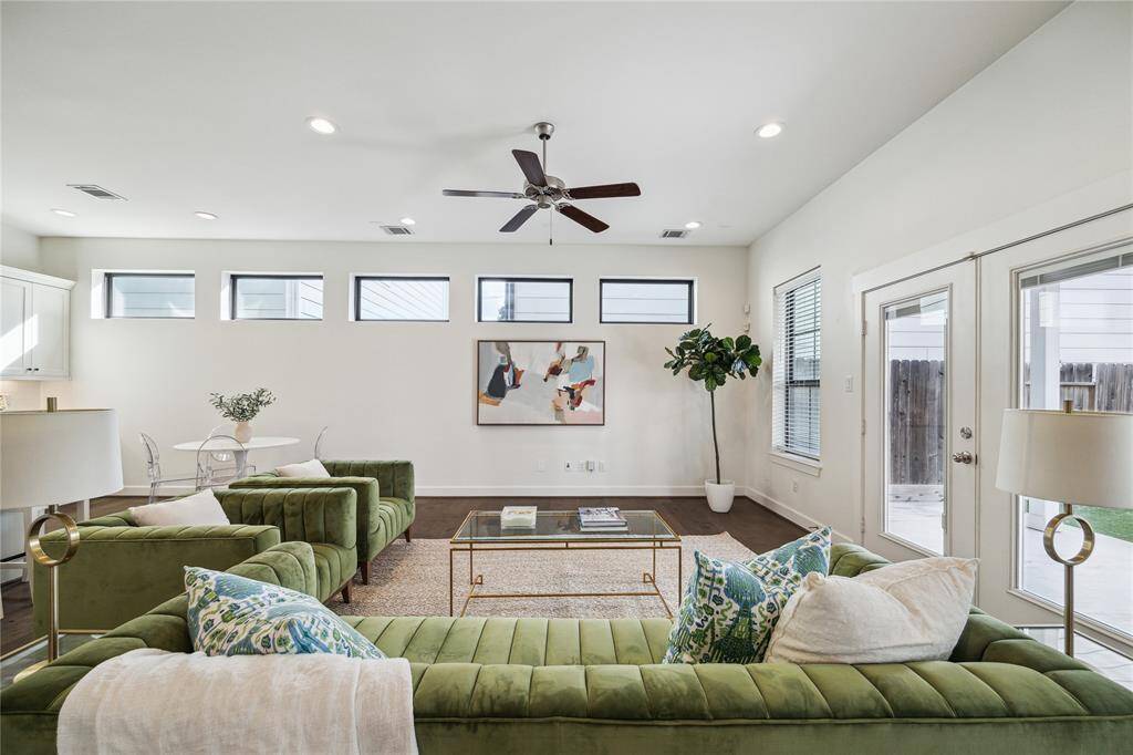 The living area is the heart of the home featuring incredible natural light, recessed lighting, and access to the backyard.