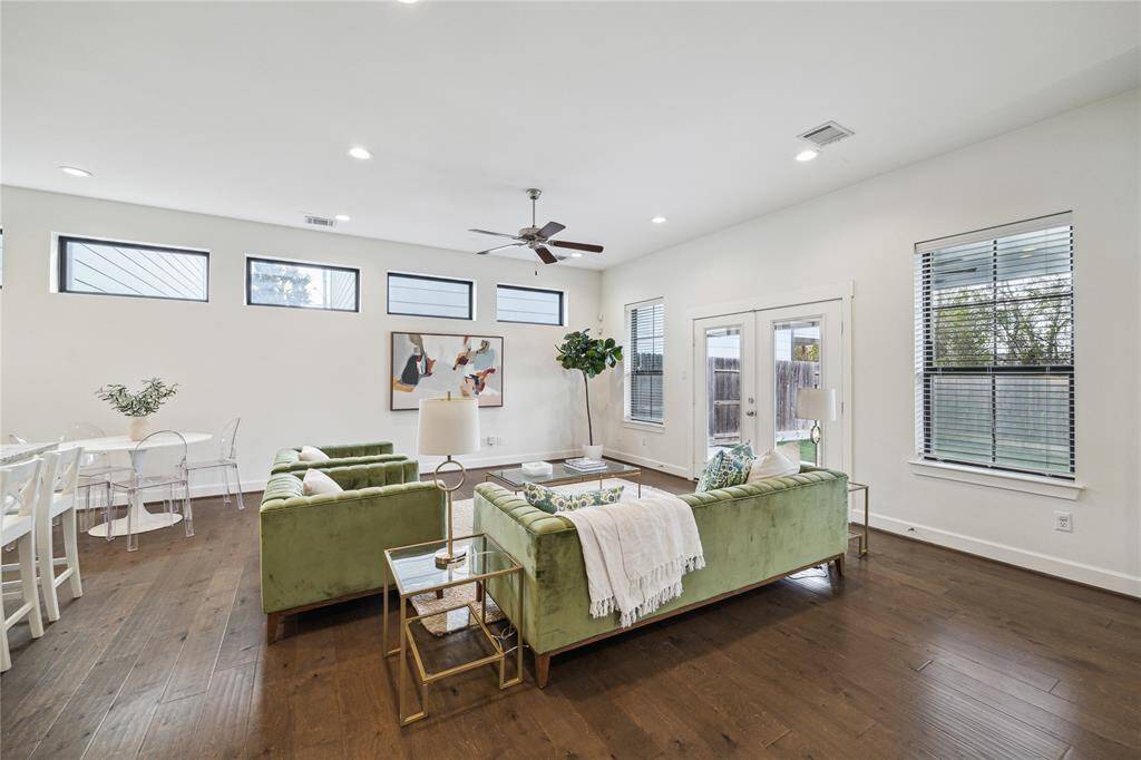 Incredible first floor living is open to the dining area and kitchen. French doors lead out to the outdoor covered living and the fenced in spacious backyard.