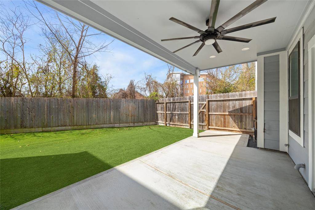 This incredible end unit offers a spacious, fenced-in turf backyard with covered outdoor living area.