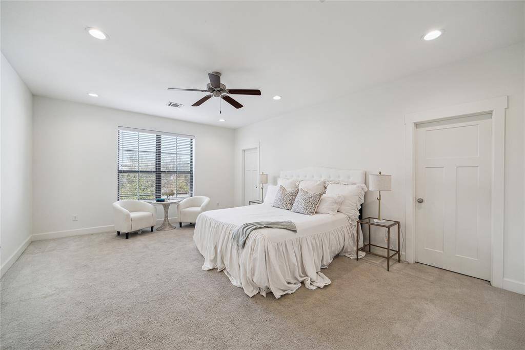 Primary suite boasts sitting area, recessed lighting, and TWO walk-in closets.