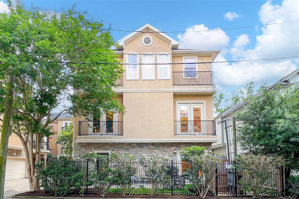 3-story single-family residence features a stunning blend of stone and stucco exterior, stylish interiors, and an unbeatable location near Memorial Park.