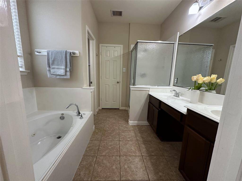 Master bedroom with double sinks and jacuzzi tub.