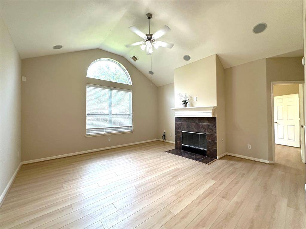 Large den with vaulted ceilings and new luxury vinyl flooring.