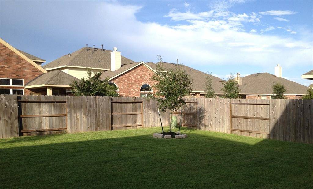 Large backyard with sprinklers.