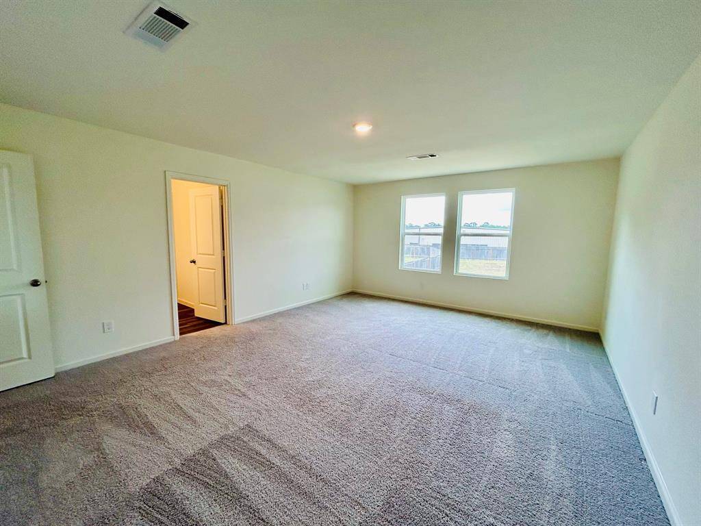 Primary bedroom with bathroom and walk in closet.