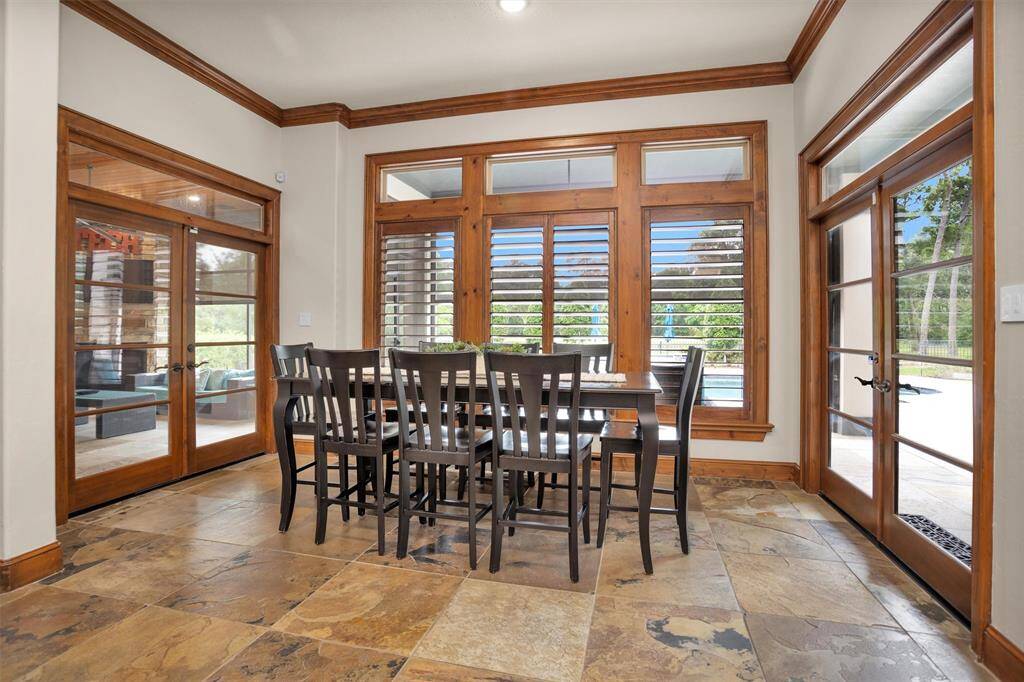 Enjoy casual dining with serene backyard views and easy access to the outdoor oasis just beyond the glass doors.