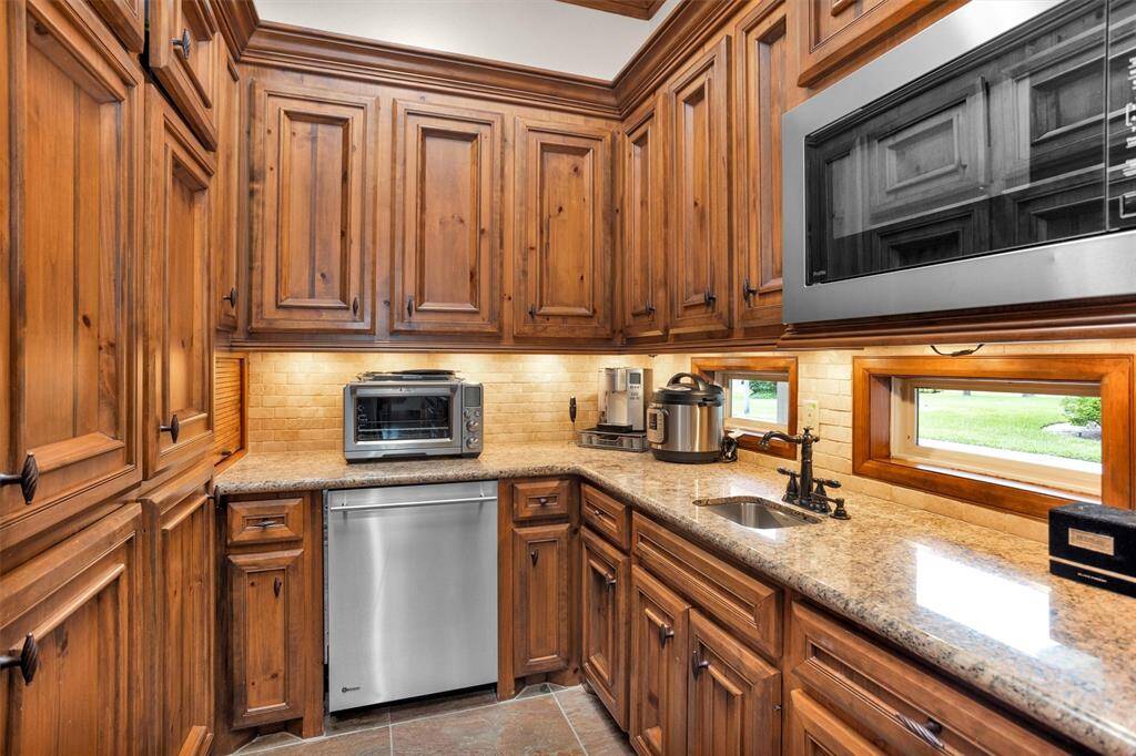 A hidden gem—this butler’s kitchen offers a second dishwasher, prep sink, and abundant storage for seamless entertaining.