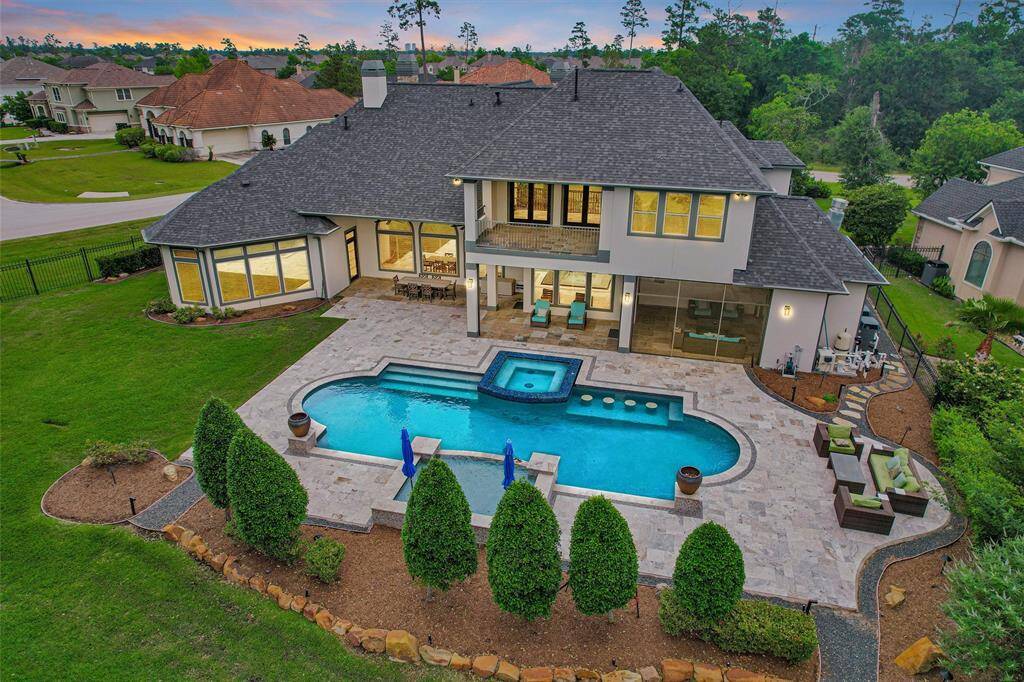 This backyard is a private paradise—custom-designed pool, spa, outdoor kitchen, and plenty of space to entertain or unwind.