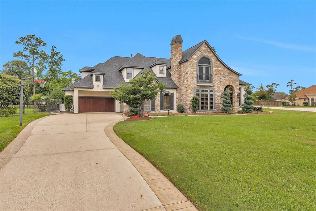 A grand front elevation with exquisite stonework and manicured landscaping sets the tone for what’s inside.