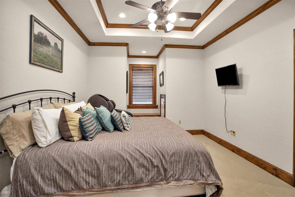 This upstairs secondary bedroom features classic crown molding and natural light—perfect for restful nights and relaxing mornings.