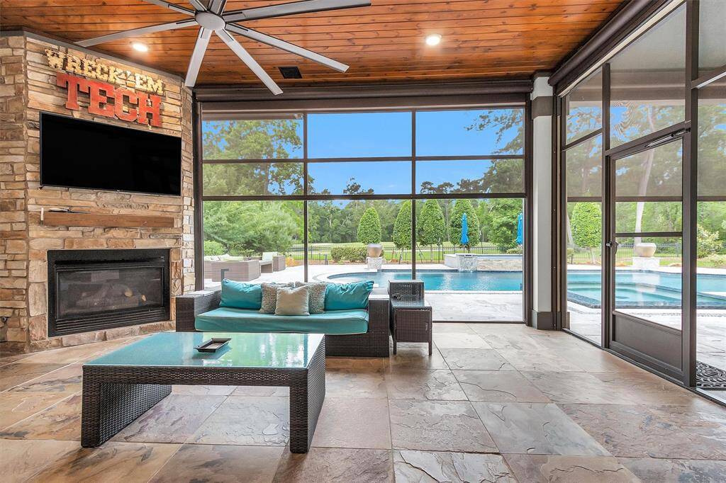 Enjoy seamless indoor-outdoor living. Oversized, remote controlled shades offer views of the pool and golf course while keeping the space shaded and comfortable.