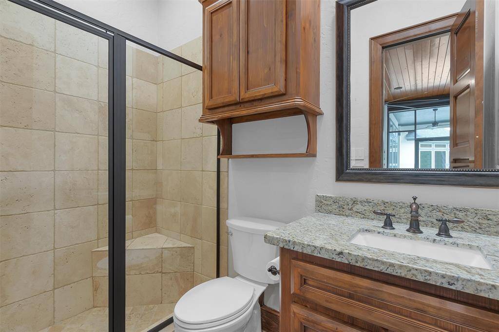 No need to track water through the house. The pool bath is conveniently located just off the patio and offers a walk-in shower, granite vanity, and custom cabinetry.