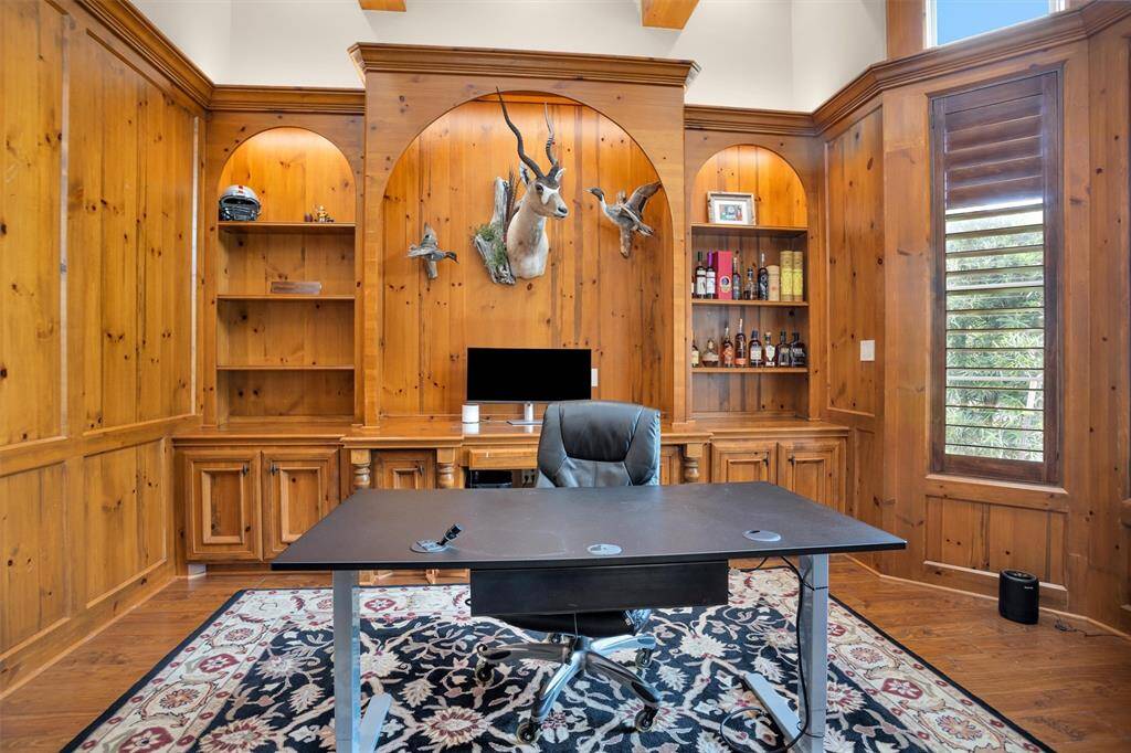Rich wood paneling and custom built-ins create an executive-style home office that blends character with function.
