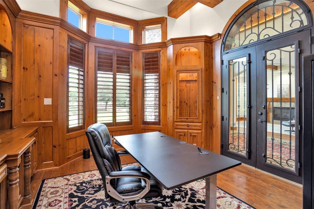 Soaring ceilings, detailed millwork, and iron French doors make working from home feel anything but ordinary.