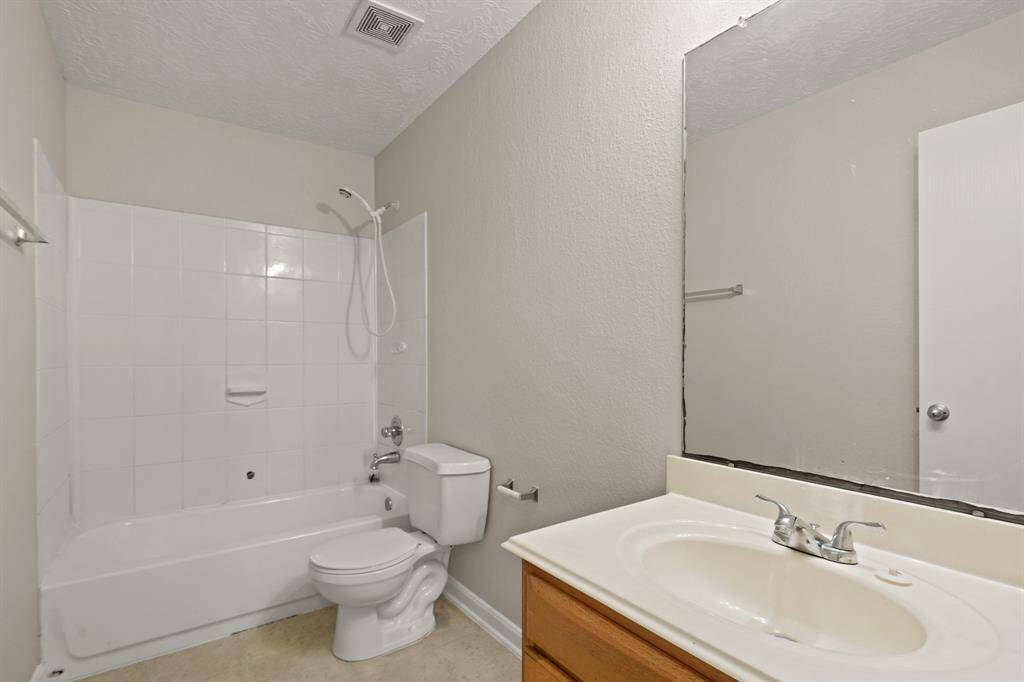 This secondary bathroom has a shower/tub combo.