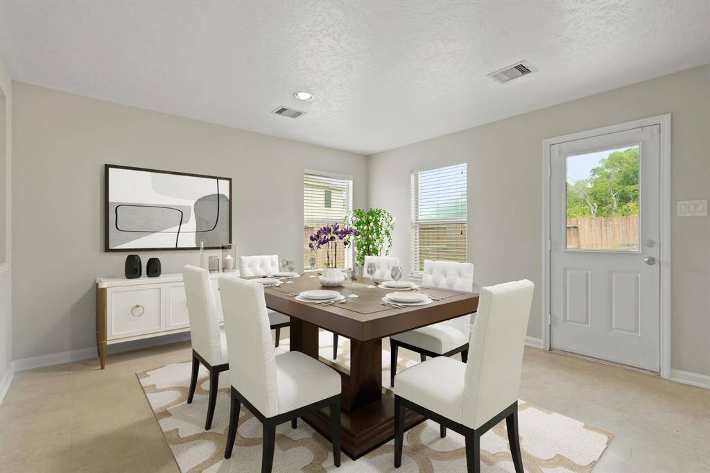 Virtually Staged: Beautiful formal dining area featuring carpet floors, and windows with privacy blinds providing beautiful views of the backyard.