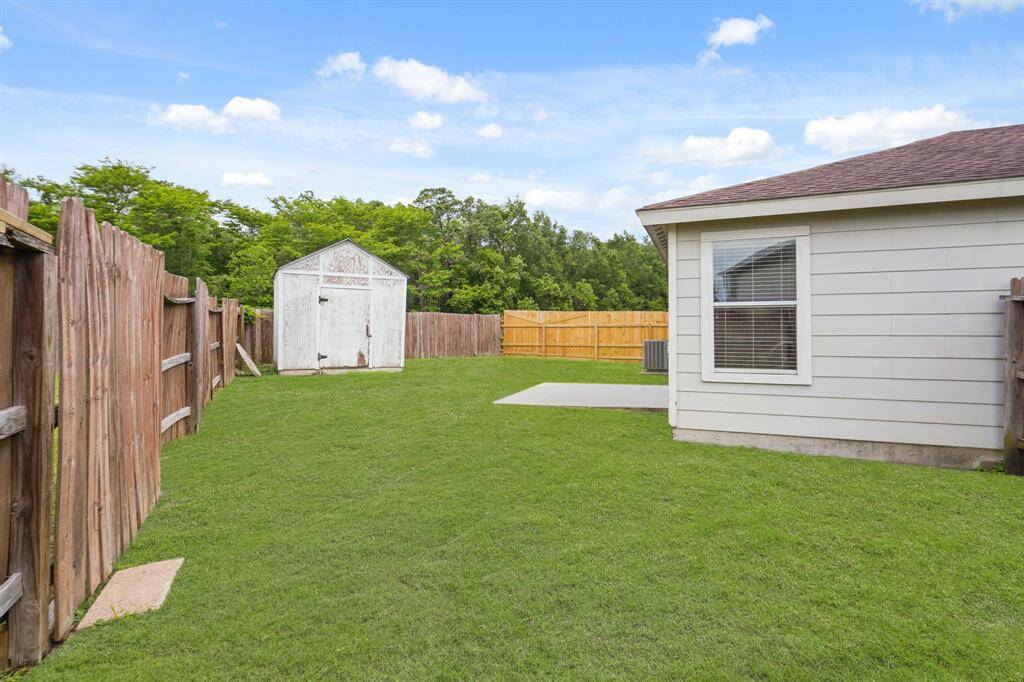 Check out all of that wonderful green space for the kids and pets to run around in. The backyard includes a storage shed.